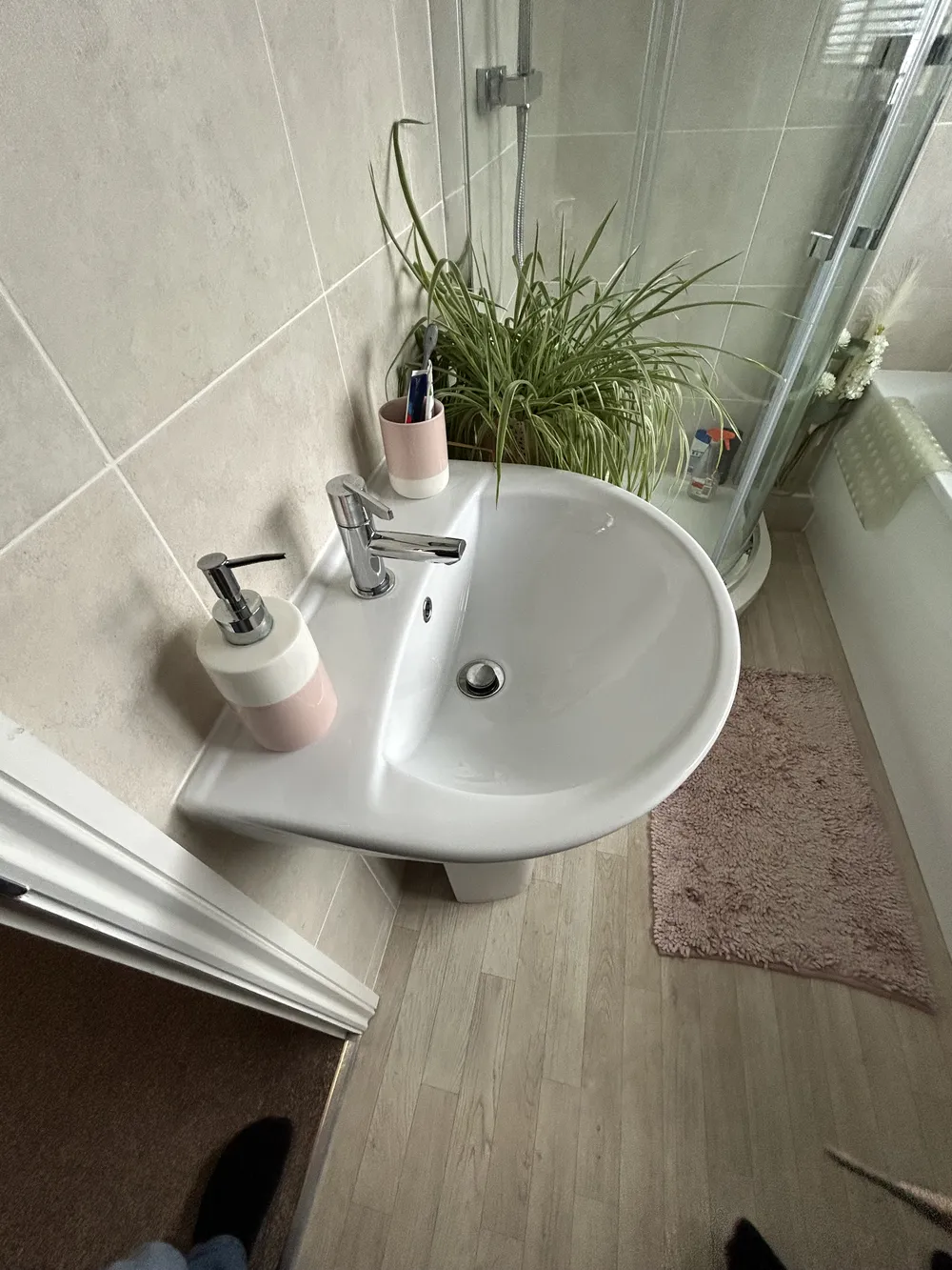 New white basin with rose gold taps fitted in a modern bathroom